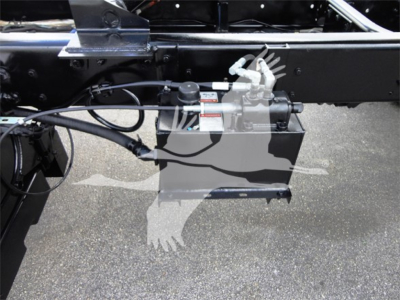 Freightliner M2 106 chassis side showing hydraulic reservoir and hoses with fittings.