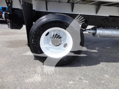 Freightliner M2 106 wheel and undercarriage view showing white steel rim and tire, chassis frame, fuel tank, and components.