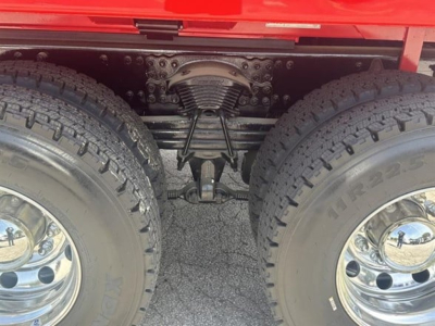 Dual rear wheels and suspension on a Western Star dump truck showing solid axle and leaf springs.