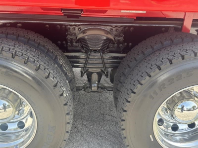 Rear view of a Western Star 47X axle area showing tandem rear suspension, differential housing, leaf springs, and twin tires.