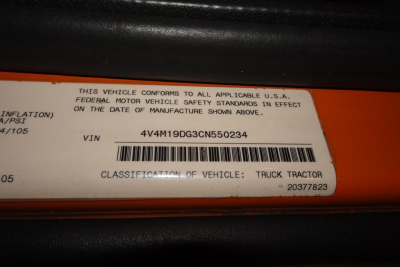 Vehicle identification label showing VIN 4V4M19DG3CN550234 and classification Truck Tractor from Volvo truck cab area.