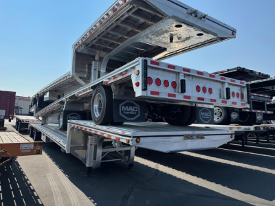 Mac drop deck trailer in-service showing rear and hydraulic ramp with MAC trailers mud flaps and reflective safety tape.