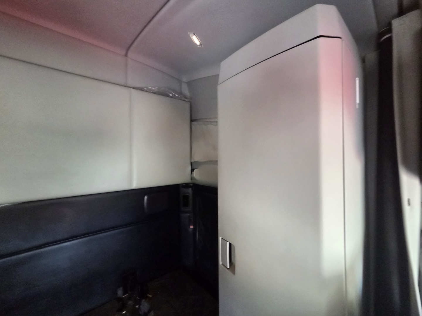 Kenworth T680 interior sleeper cab corner with storage cabinet and side panels visible.