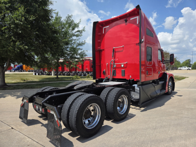 Kenworth T680 conventional sleeper rear view showing cab and dual rear tandem wheels with red paint and visible exhaust stack