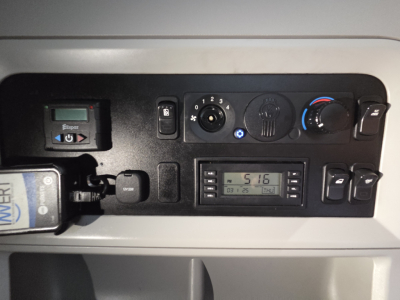 Dashboard panel of a Kenworth truck showing controls, digital display, and knobs; visible text includes 'POWER' on a switch, 'MPH' on a display, and various numbered controls.