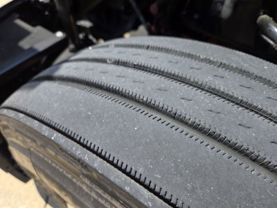Kenworth T680 truck wheel/tire close-up showing tread and sidewall details.