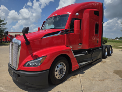 Kenworth T680 semi truck in red, front three-quarter view showing cab, chrome grille, and dual rear axles; no visible text on components.