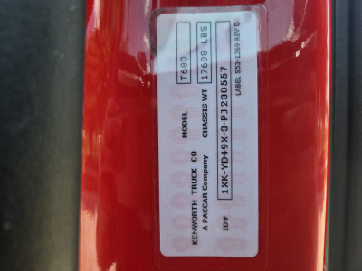 Kenworth T680 VIN/sticker label on red truck frame showing model T680, CAN/GBL with 17680 lbs axle? and serial numbers. Text includes MODEL T680, KENWORTH TRUCK Co, A PACCAR Co, 1XKYD49X3PJ230557.