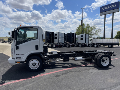 Isuzu NRR cab and chassis in white with flatbed skeleton frame, side view showing chassis and rear wheels under a blue sky.