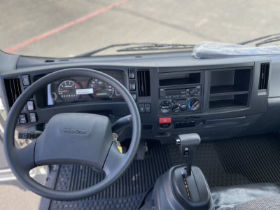 Isuzu NRR-GAS cab and chassis interior view showing steering wheel, dashboard, and gear selector with standard instrument cluster.