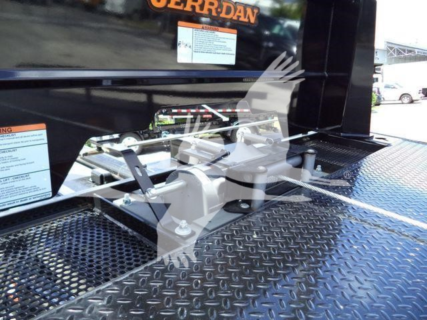 Truck bed area of a 2027 International MV rollback truck showing platform, controls, and diamond plate surface.