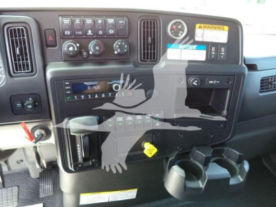 Dashboard view of a 2027 International MV rollback truck showing control panel, gauges, cup holders, and ignition area.