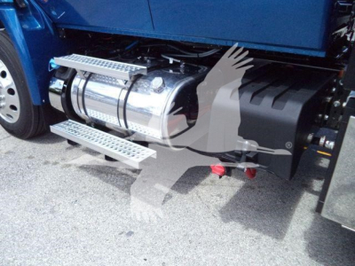 Truck side view showing polished cylindrical fuel tank and metal side steps on a blue International MV truck.