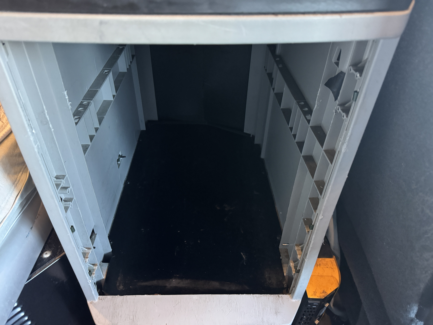 Kenworth T680 cab storage area showing empty sleeper compartment with light gray interior and open entry