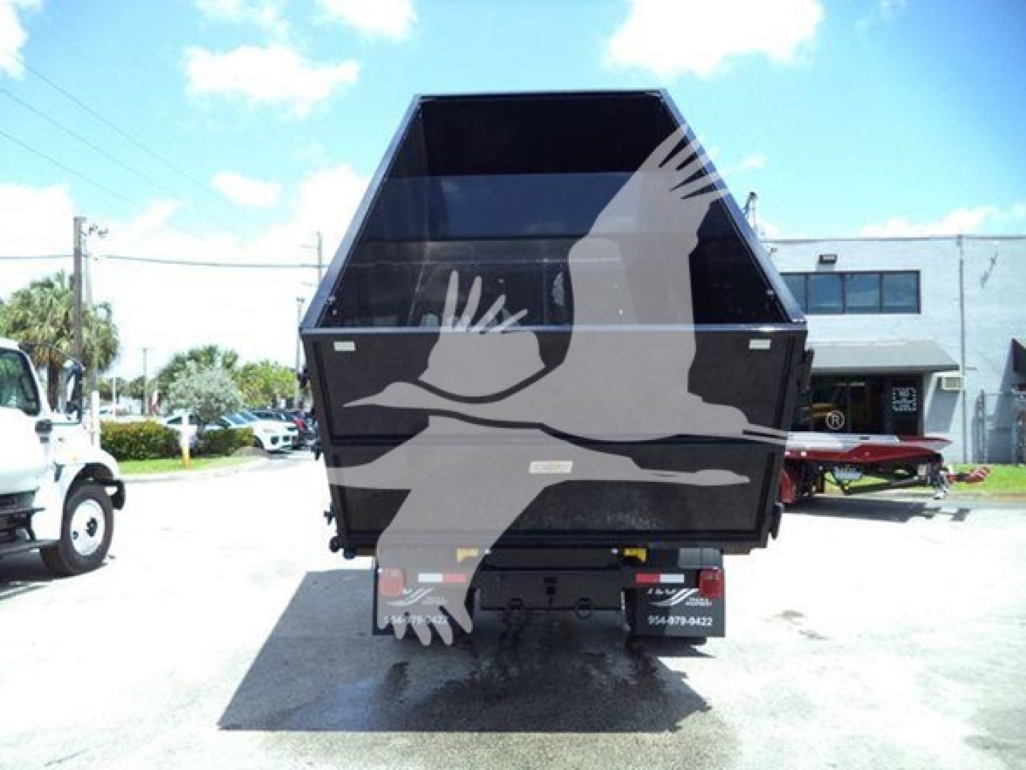 Dump truck bed showing dump body and rear view with tail lights and license plate area.