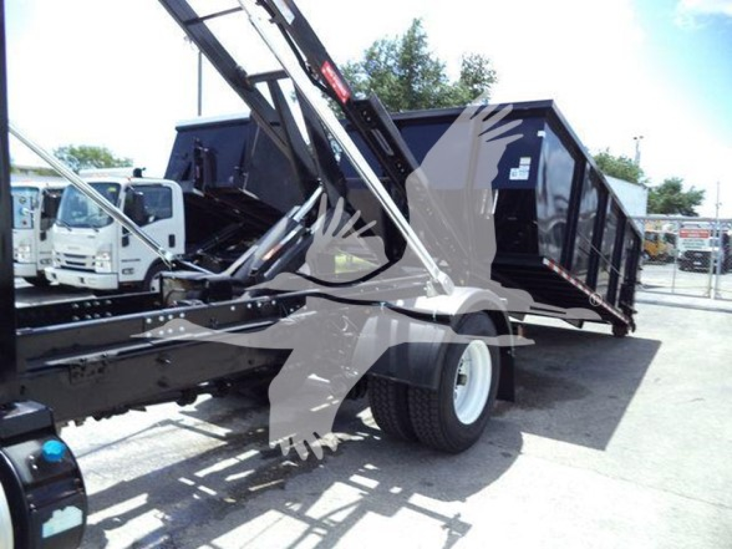 Truck bed with hydraulic hoist and dump body on International Durastar 4300 showing midsection and rear wheels.