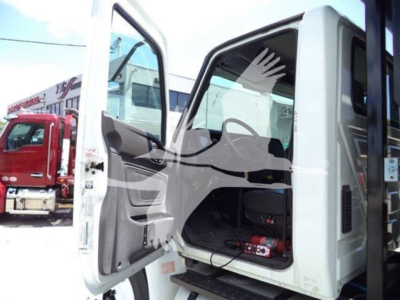 Truck cab interior with front door open showing seating and dashboard area.