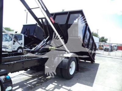 2019 International Durastar 4300 dump truck with raised bed and hydraulic arm, side view showing rear wheel and truck bed.