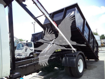 Truck chassis and dump body with hydraulic lifting arms in operation on a dump bed, International Durastar 4300, 2019 model, roll-off truck