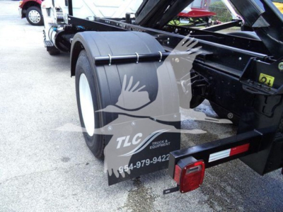 Truck chassis side view showing rear dual wheels and frame with fender and taillight assembly; TLC truck equipment watermark overlay