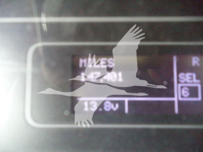 Vehicle dashboard display showing 13.8V and a partial VIN plate text in a rollover truck listing image.