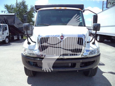 Front view of a white 2019 International Durastar 4300 roll-off truck with chrome grille, large bumper, mirrors, and logo; no visible text on badges due to glare.