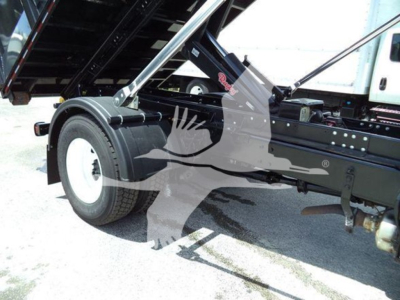 International 4300 roll-off truck showing rear wheel and frame with hydraulic components.