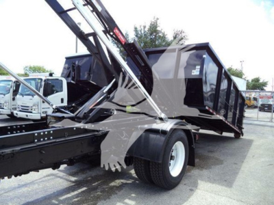 2019 International Durastar 4300 roll-off truck showing a hydraulic crane and dumping container with black body and white wheels.