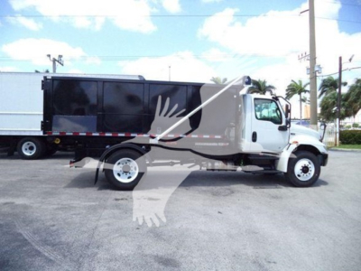 2019 International Durastar 4300 roll-off truck side view with white cab and black container
