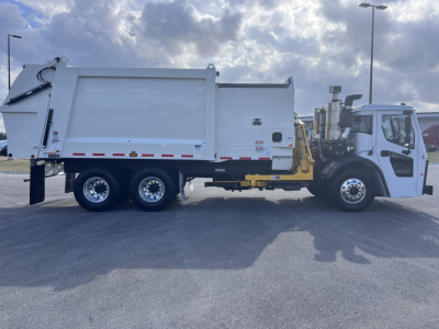 Mack LR64 truck side view showing garbage truck body and hydraulic lift system