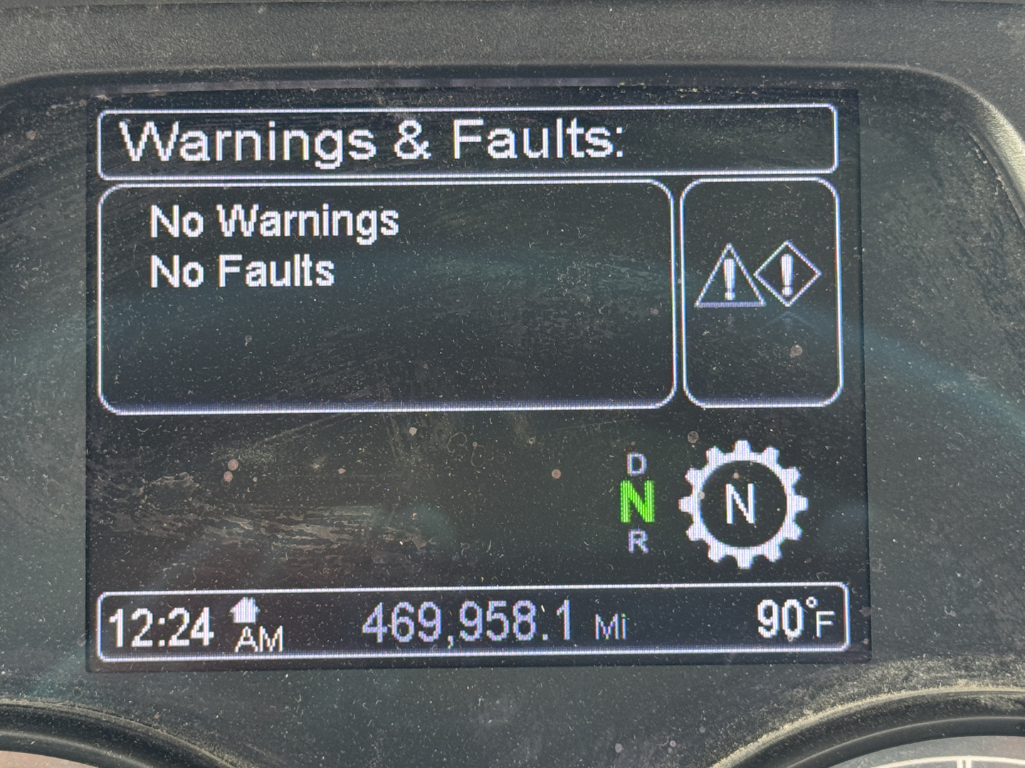 Panel showing 'Warnings & Faults: No Warnings No Faults' with gears icon and D N R indicators, odometer 469,958.1 Mi, time 12:24 AM, outside temp 90°F.