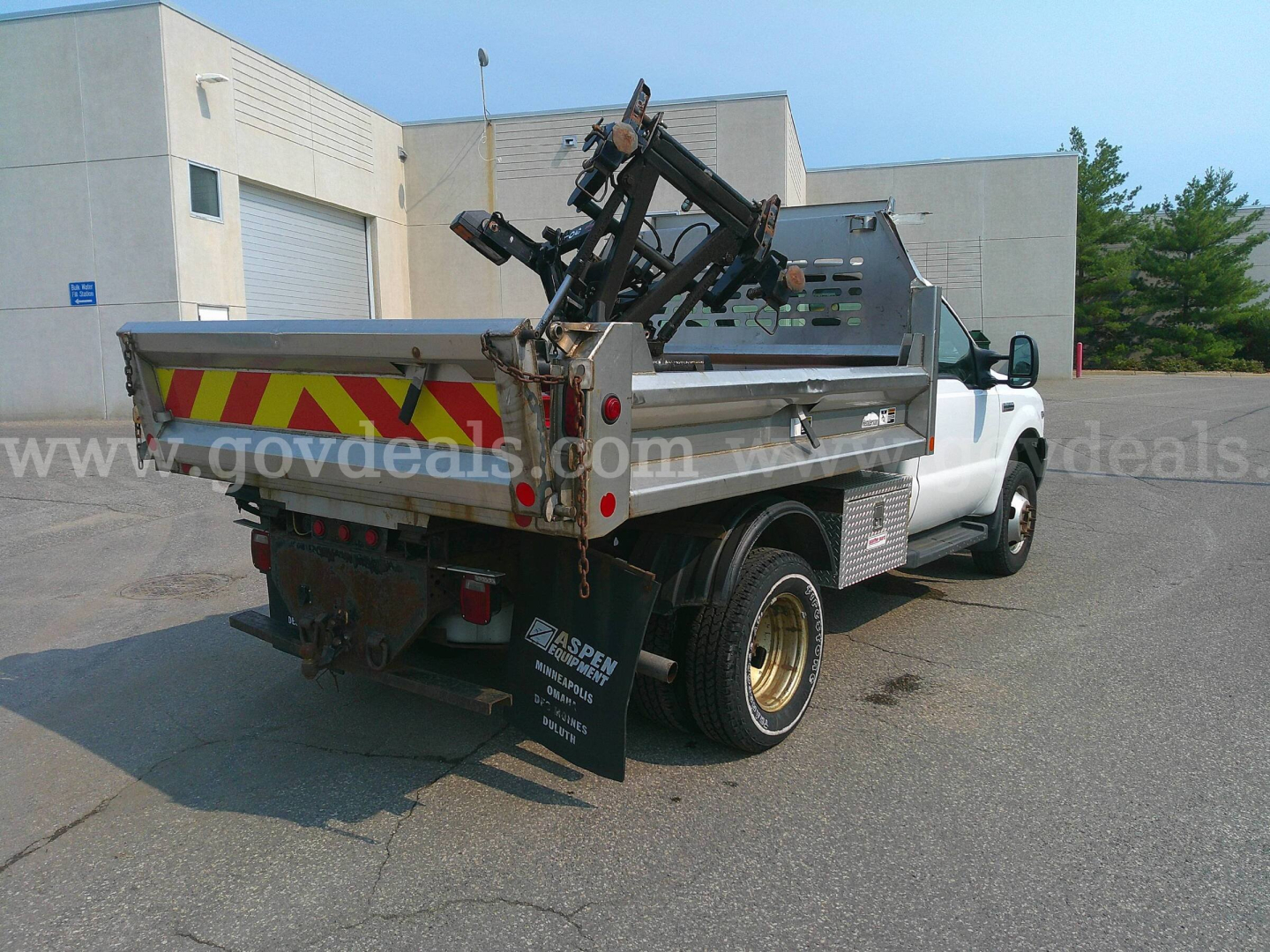Ford F-350 dump truck rear view showing hydraulic lift and reflective chevron tape