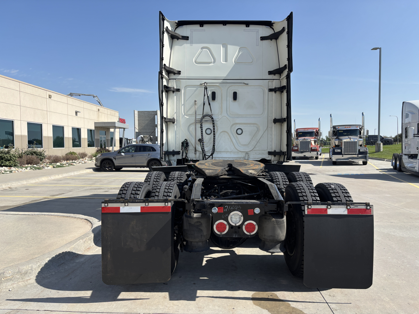 Freightliner PT126064ST rear view showing chassis, dual rear axles, fifth wheel mounting and mud flaps with reflectors.