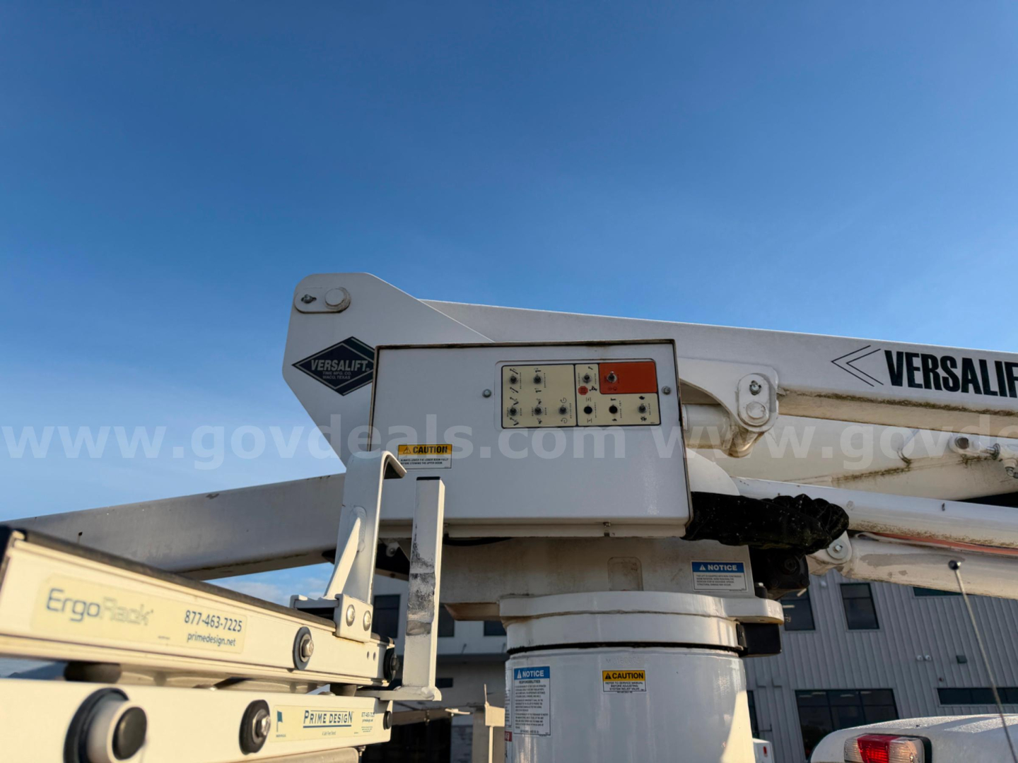 Ford bucket truck boom and base showing Versalift equipment label and control panel