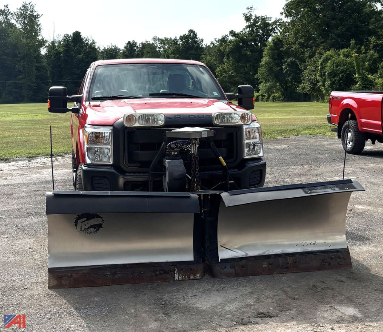 Ford F-250 Super Duty pickup with front snow plow attachment, 2016 model year, red cab, black grille, two plow blades mounted forward.