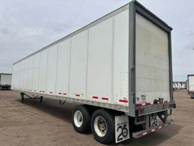 Trailer side view of a 2016 Wabash van semi-trailer showing dual rear axles and rear doors.