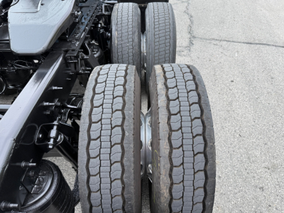Truck rear dual tires of International LT625 chassis showing tread pattern and axle assembly.