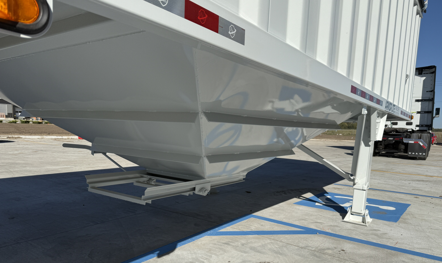 New Armor Lite 40' steel grain hopper trailer axle area with landing gear and undercarriage in view showing hull label decals