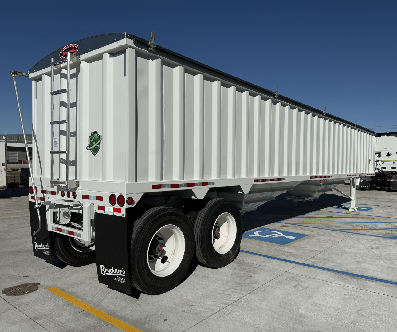 Armor Lite 40' steel grain hopper trailer with dual axles and rear ladder, white exterior, parked on lot.