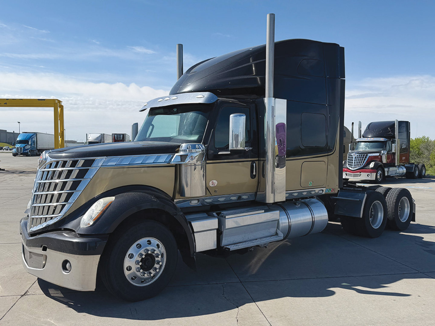 2022 International LoneStar conventional sleeper truck side view showing chrome front grille, dual exhaust stacks, and sleeper cab.