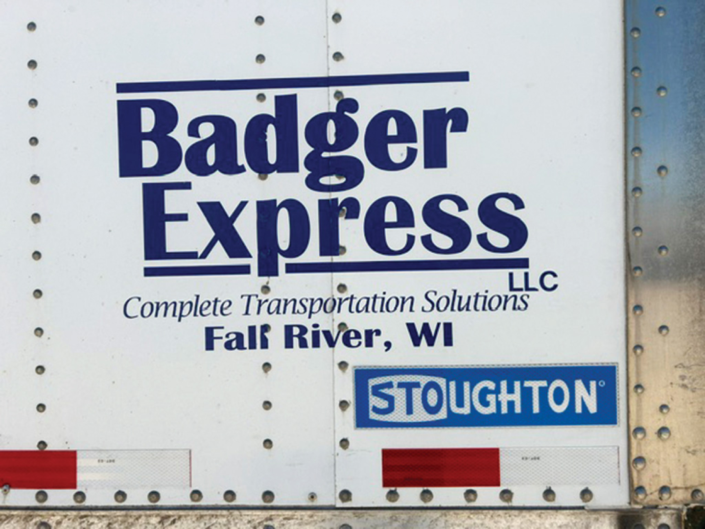 Trailer side with Badger Express logo and Stoughton label showing Fall River, WI; Stoughton brand badge.