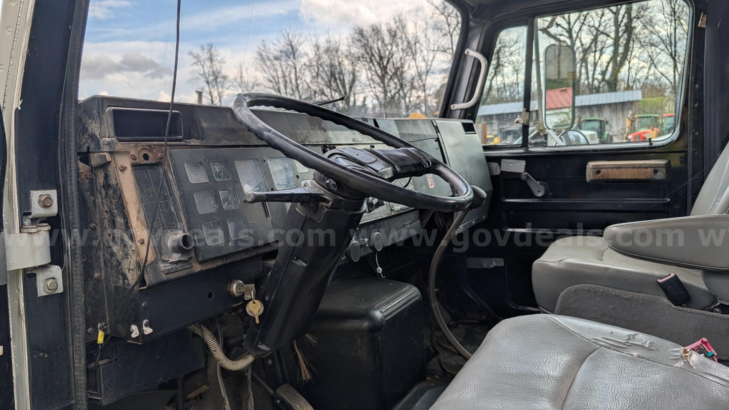Truck cab interior of an International 4700 showing basic dashboard and steering wheel in view.