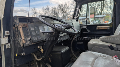 Truck cab interior of an International 4700 showing basic dashboard and steering wheel in view.