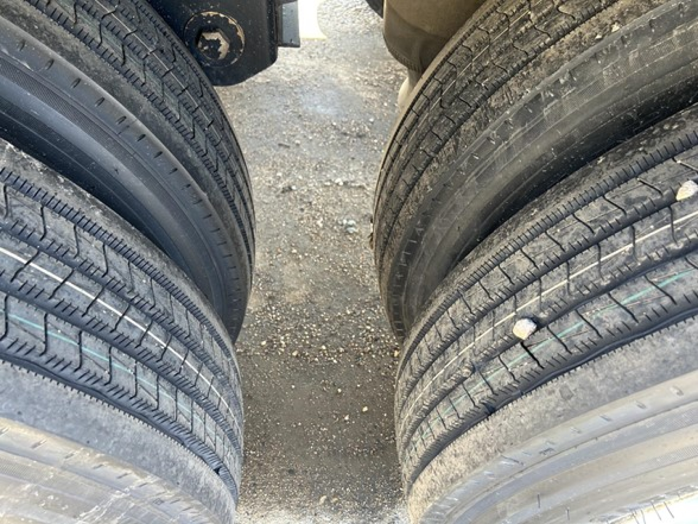 Truck trailer tires view showing dual axles and tread patterns for Jet Air Ride Side Dump trailer.