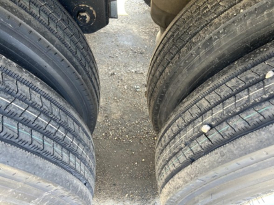 Truck trailer tires view showing dual axles and tread patterns for Jet Air Ride Side Dump trailer.