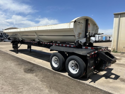 Jet Air Ride Side Dump trailer showing cylindrical rear hopper and dual-axle tandem wheels.