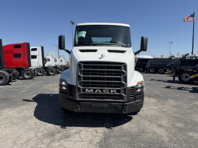 Front view of a white 2027 Mack AN64T conventional daycab truck with large grille and Mack logo, in a dealership lot.