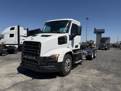 Truck front-left view of a white 2027 Mack AN64T conventional daycab with dual rear axles and Mack grille.
