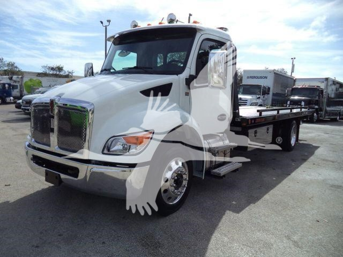 Kenworth T280 tow truck side view showing white cab and flatbed, with chrome front grille and side mirrors.