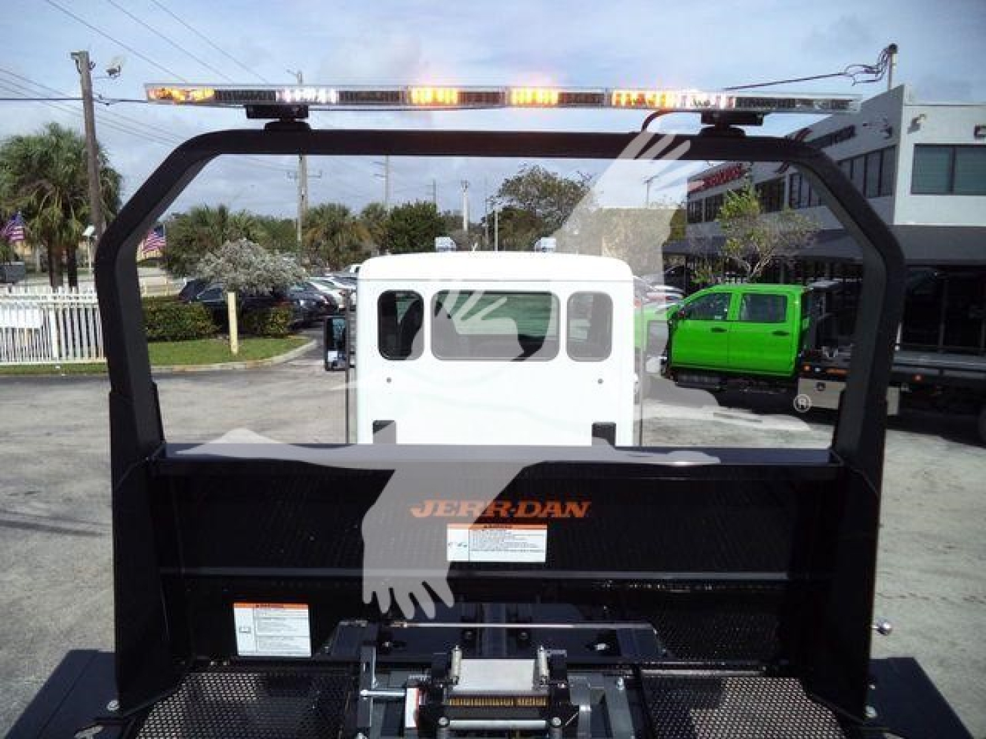 Kenworth rollback truck bed with a white cab visible through the rear window and an orange 'JERR-DAN' logo on the bed.